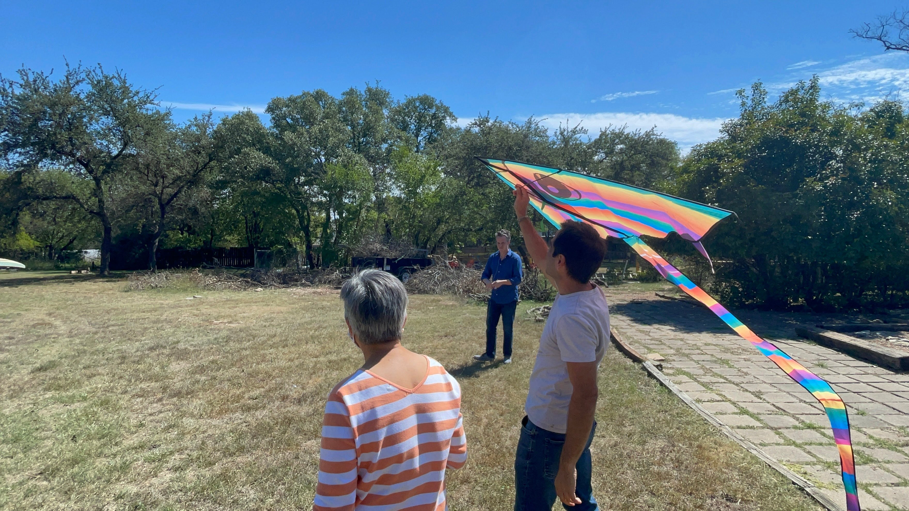 GivePulse team members flying a kite in an open grassy field