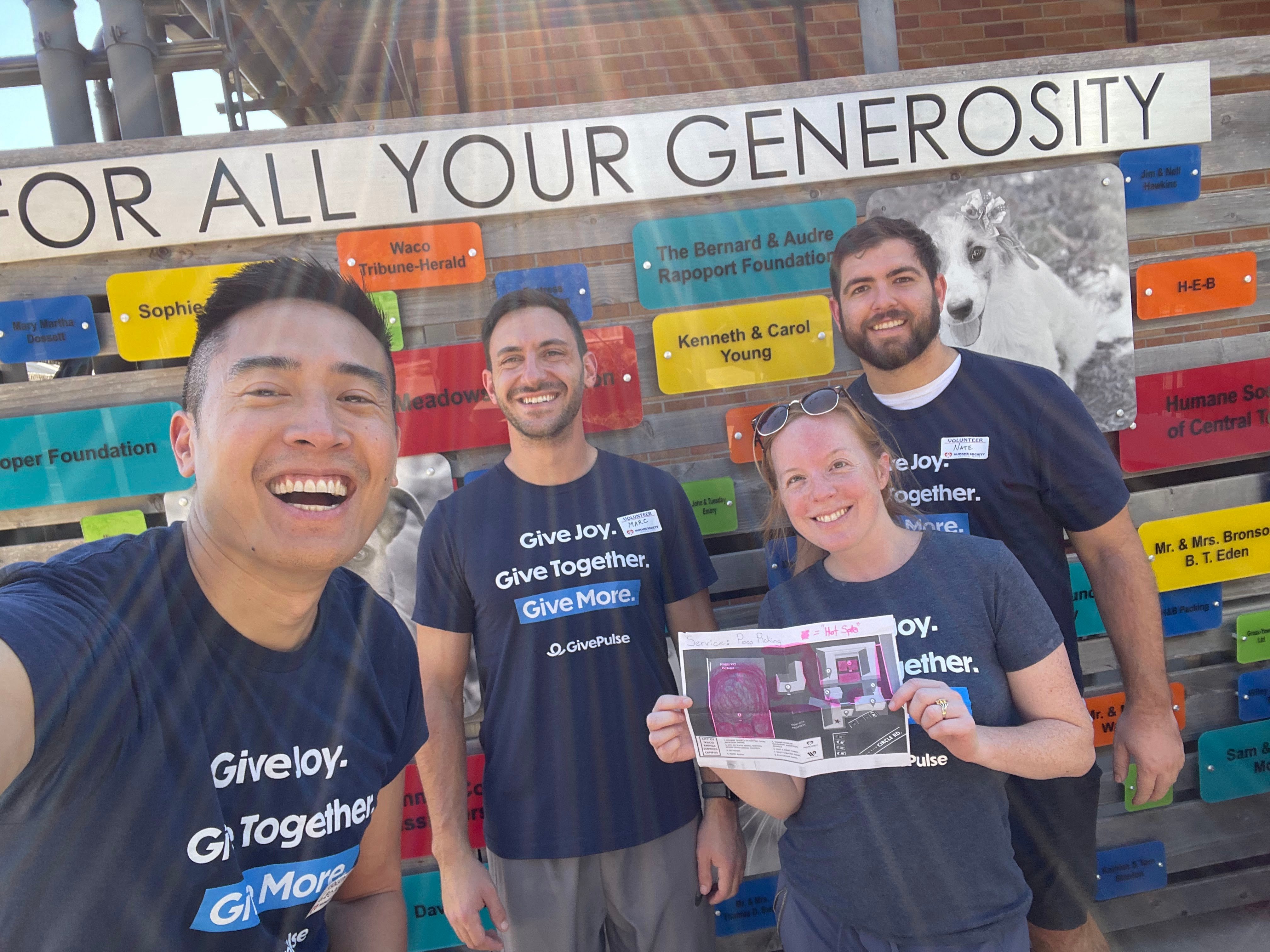 CEO George Luc and GivePulse team members taking a selfie while volunteering at the Humane Society of Central Texas on the '22 company retreat. 