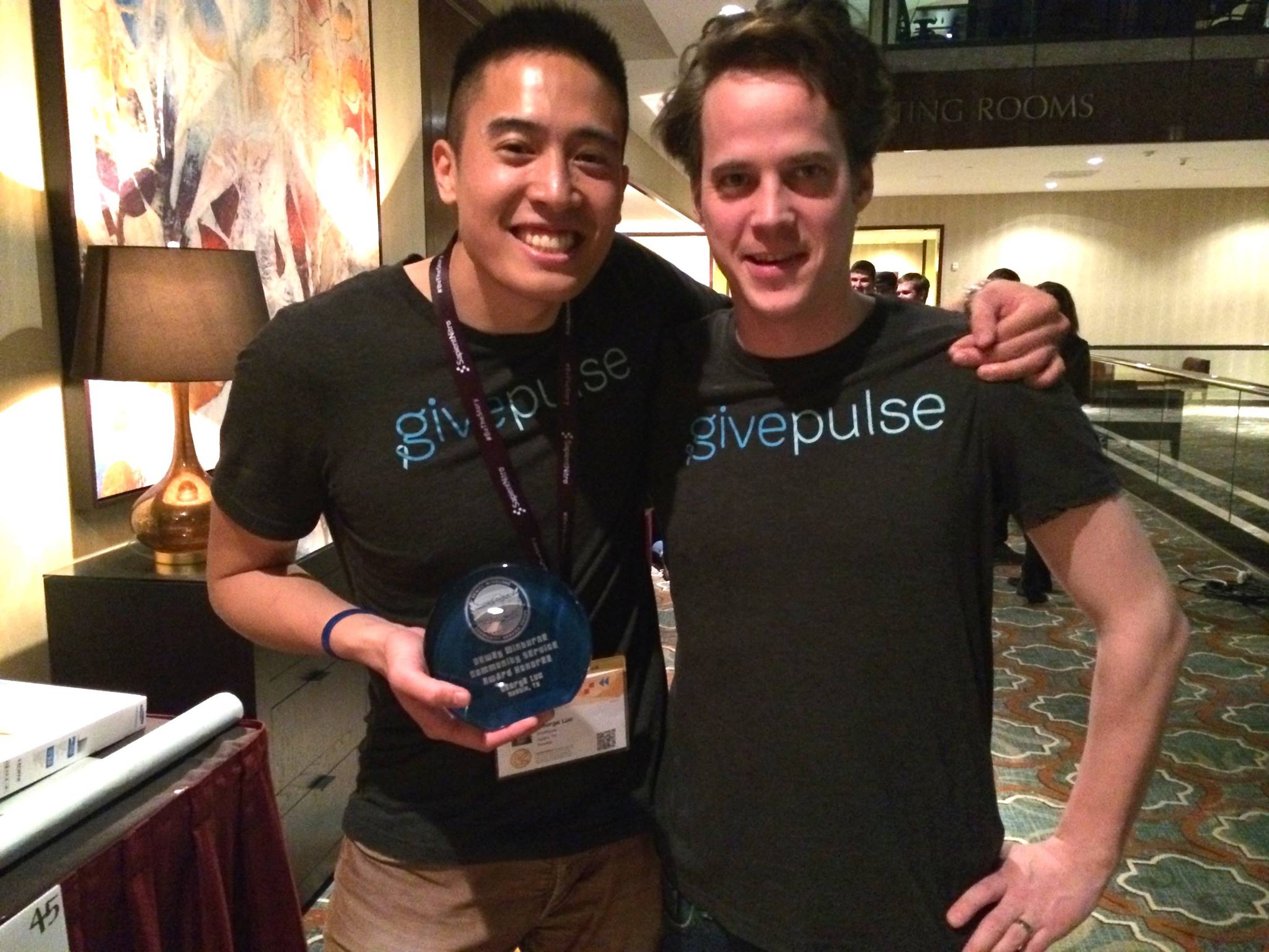 George Luc and GivePulse cofounder James McGirr at the ATX Startup Crawl holding the Dewey’s civic award. 