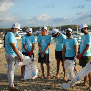 Group of GivePulse volunteers cleaning up the beach