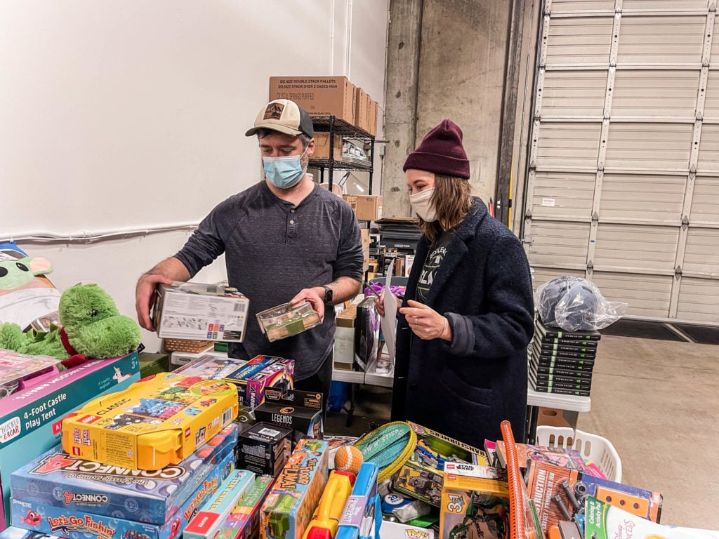Two volunteers from Brown Hope's holiday free store event organizing toys and gifts, helping nurture the seeds of social justice 