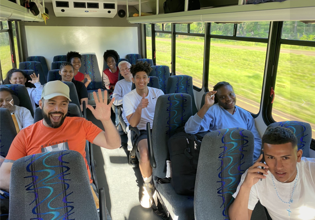 Group of RAICES members on a bus from a protest