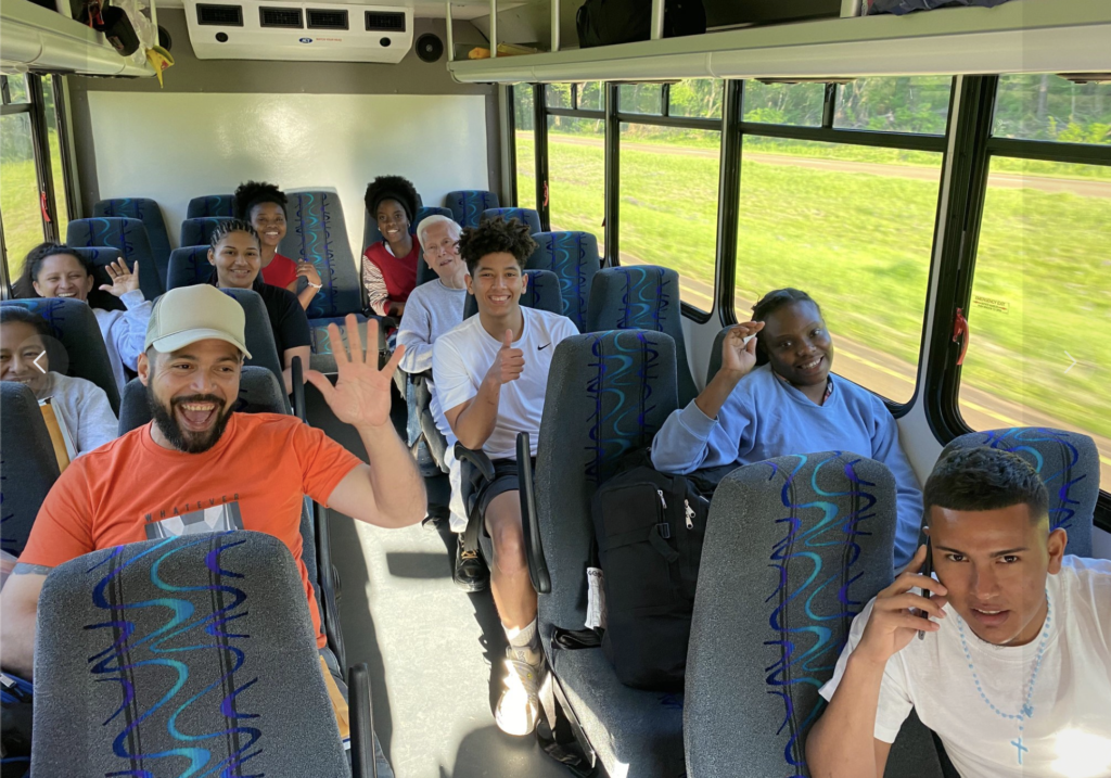 Group of RAICES members on a bus from a protest 