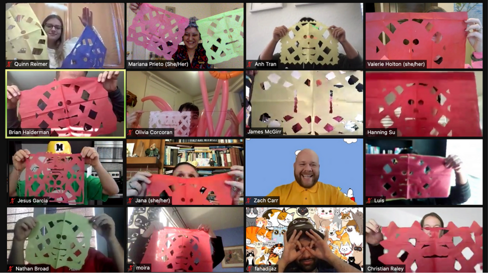GivePulse team on zoom holding up the Papel Picado they made