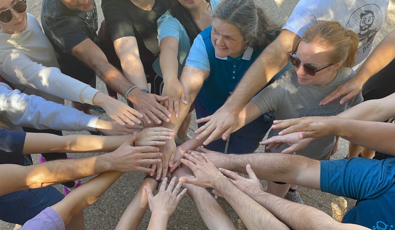 GivePulse Team joining hands in the spirit of teamwork!