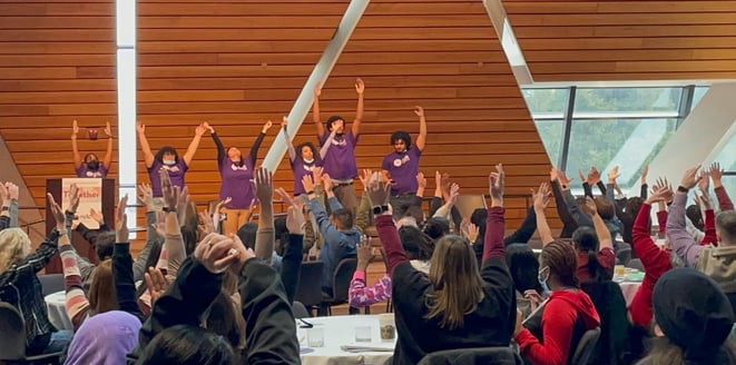 Students at the National Youth Leadership Council dancing and presenting on stage at the 2022 annual conference 