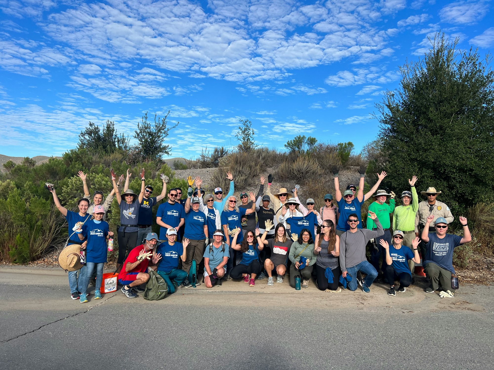 A group picture of corporate volunteers at a local park 