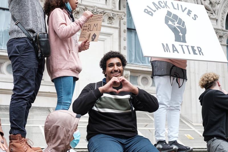 People are marching and protesting to show love and compassion for social movements.