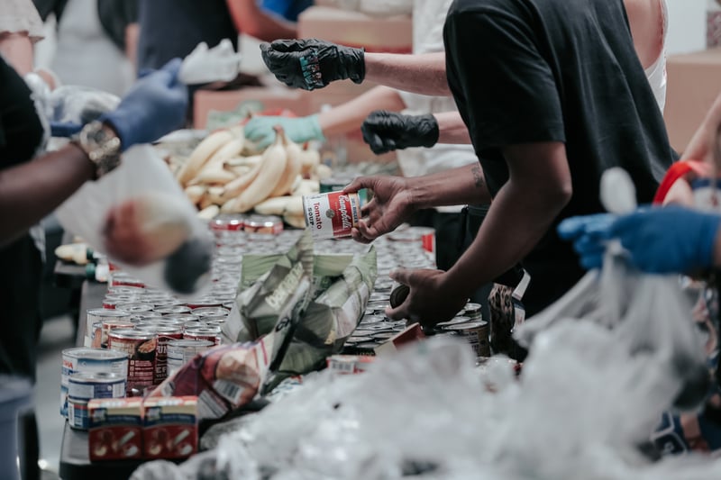Volunteers helping a local nonprofit organize food donations at a food bank 