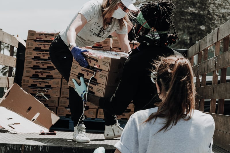 Volunteers packaging and delivering food from a food bank 