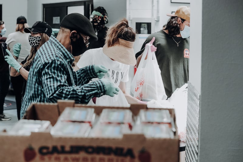 Volunteer packaging and passing out food to those in need