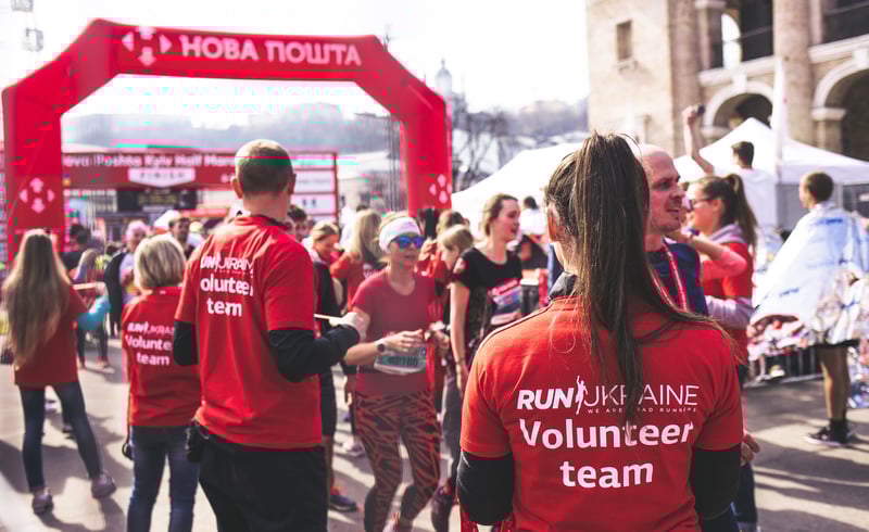 Volunteers helping to pass out food and water at the finish line of a 5K, 10K race 