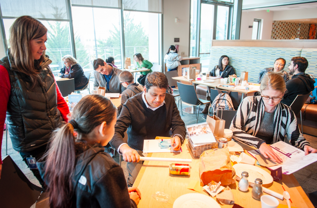 Genentech employees sign up for volunteer opportunities, like the mentoring pictured here, through a CSR technology platform