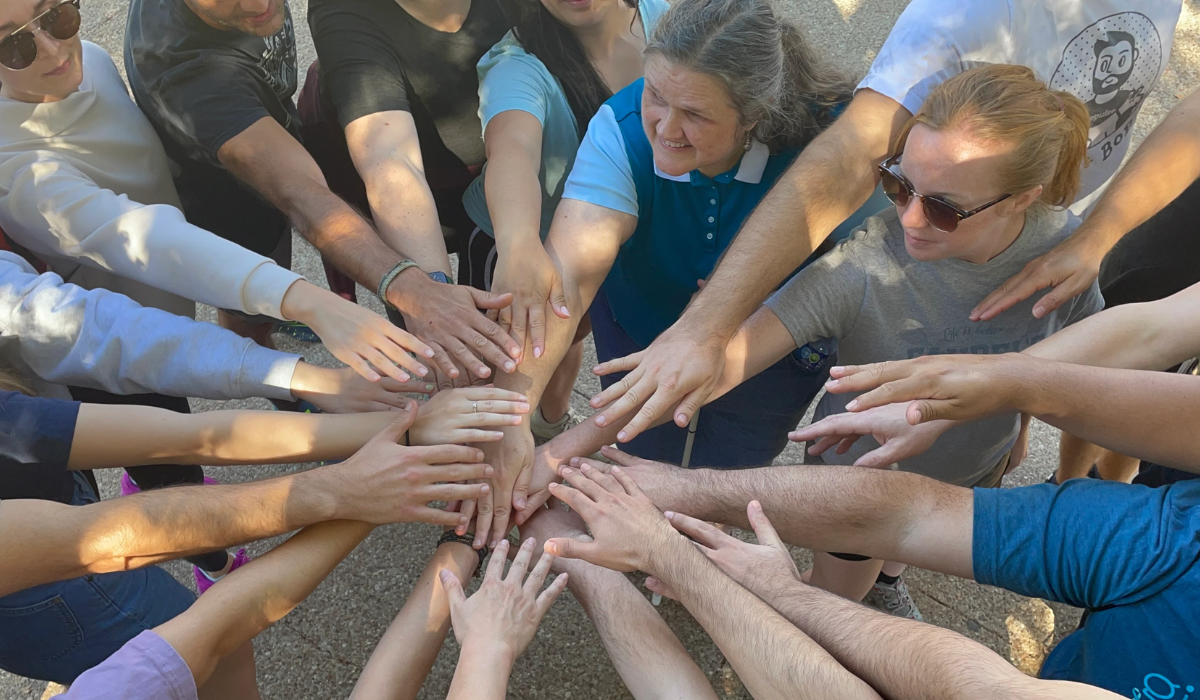 GivePulse Team joining hands in the spirit of teamwork!