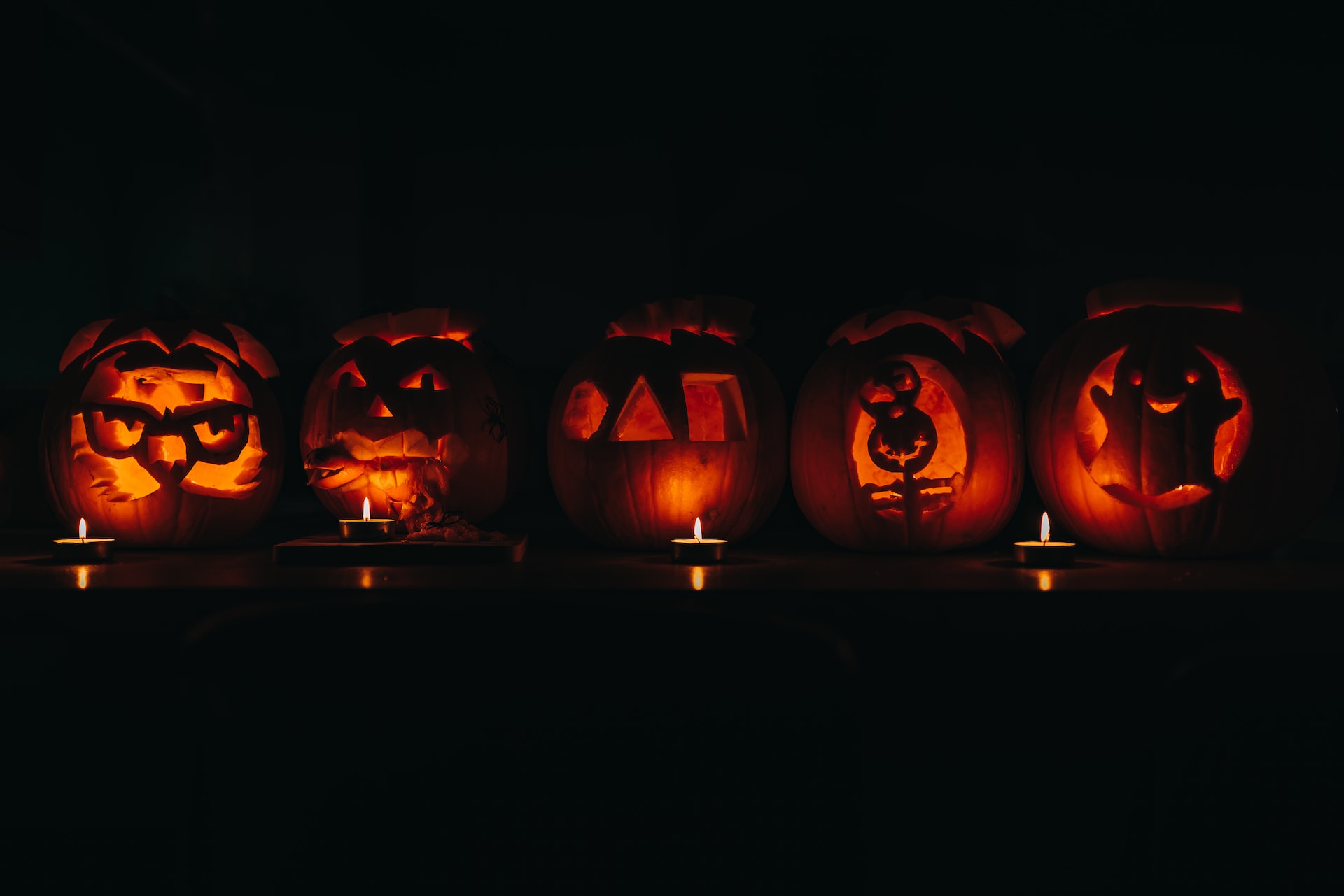 Five jack-o-lanterns in a row.