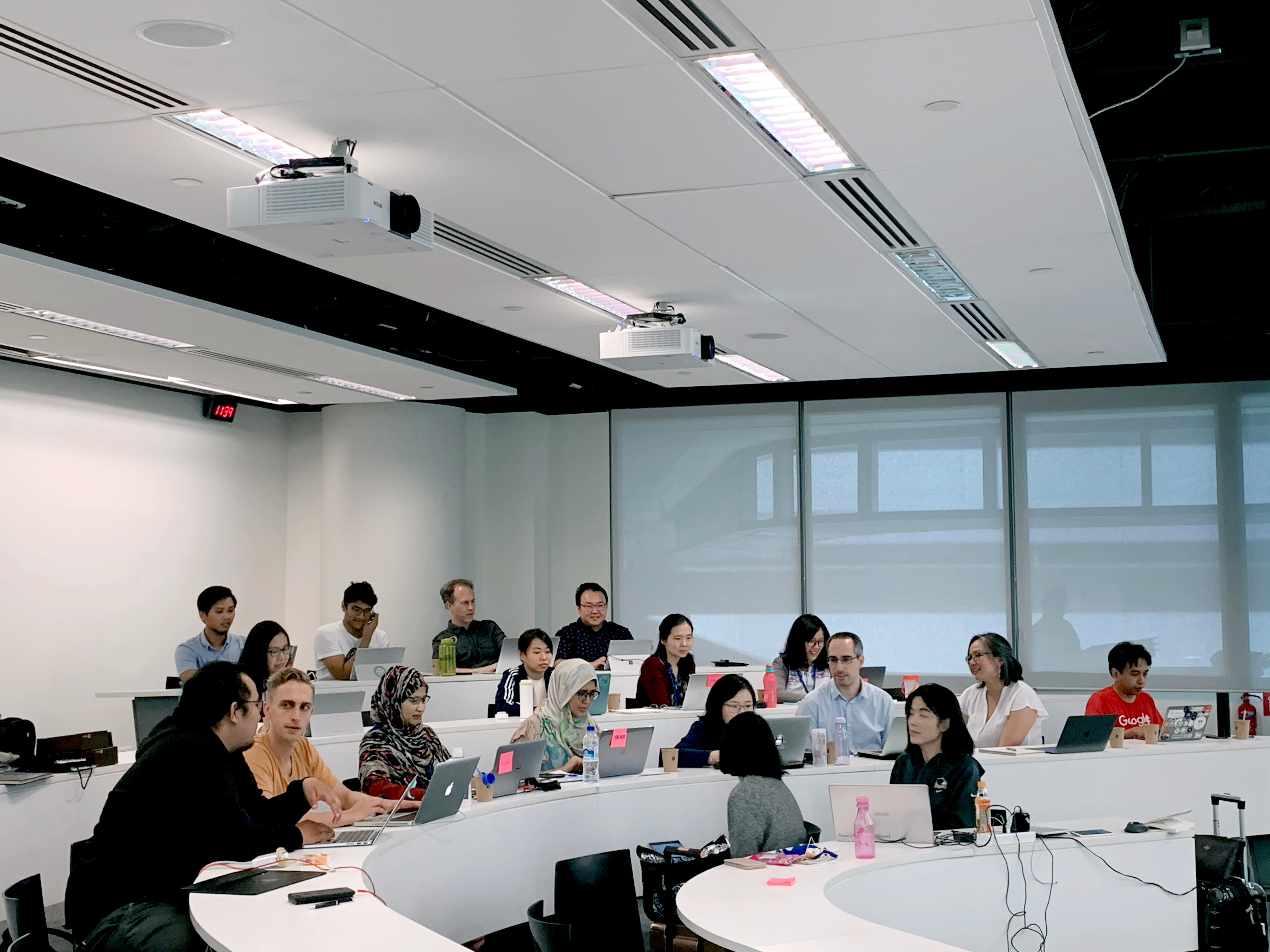 Students sitting in a lecture hall at a college or university engaging in meaningful dialogue