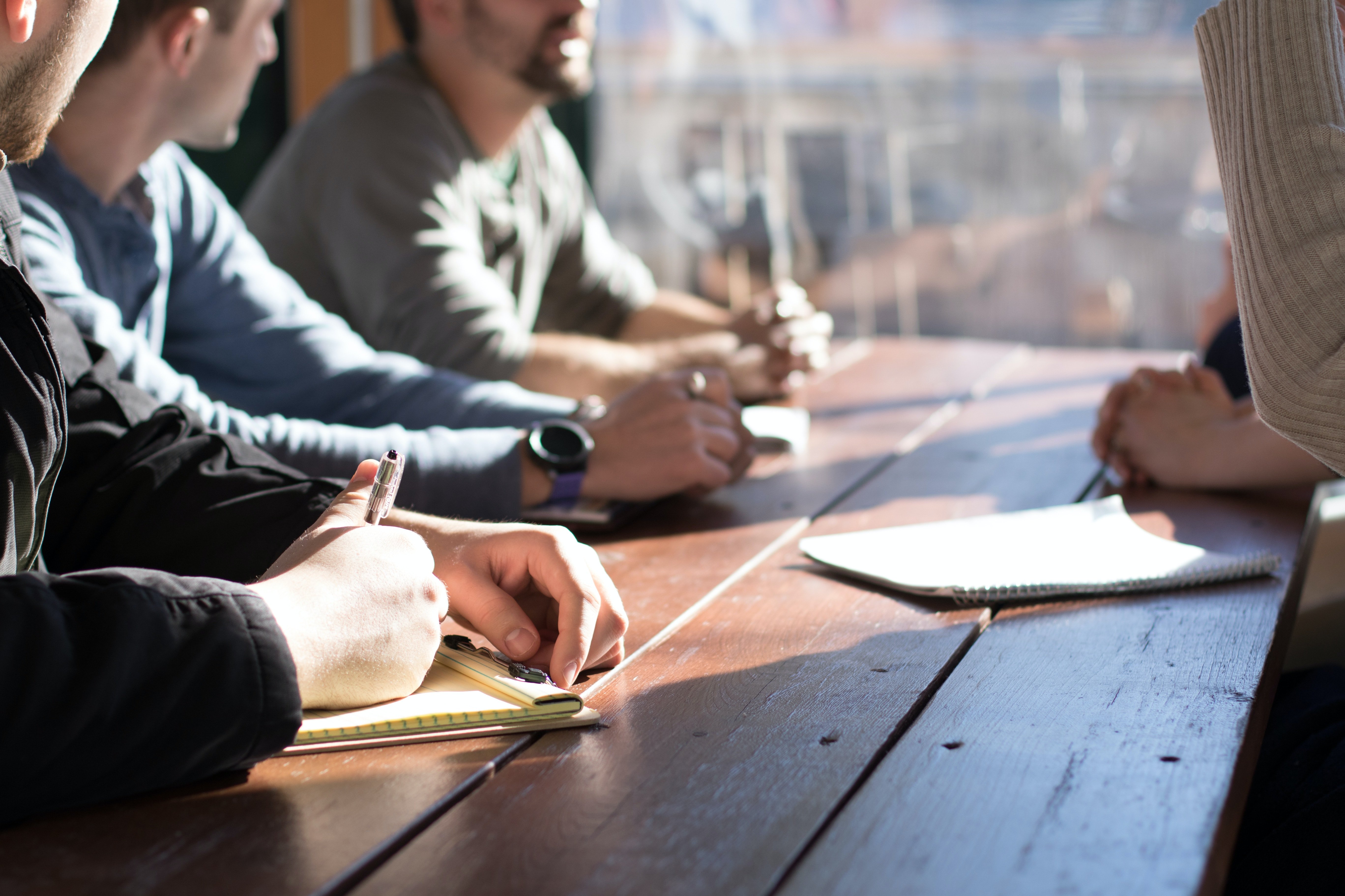 Students sitting at a picnic table studying 