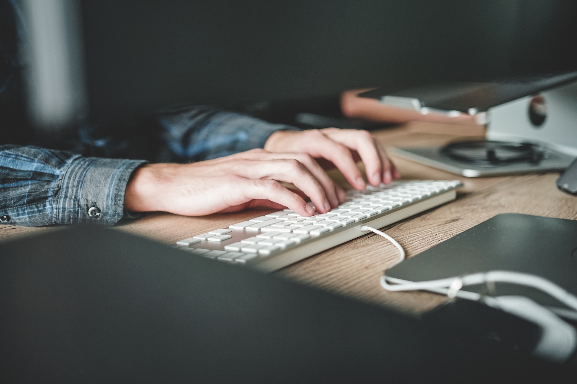 Hands typing on a keyboard.
